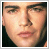 Pixelated close-up of a person's face with visible facial features and dark hair against a light background.