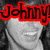 Black-and-white image of a person with curly hair, red text overlay reading 'Johnny', and a gray rectangular area on the right side.