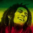 Pixelated image of a person with long dark hair and a red garment against a green-yellow background, with yellow text on a red field reading ONE, LOVE, and ONE HEART.