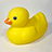 Yellow rubber duck with blue eye and orange beak on light gray background, next to pixelated text on bright orange field.