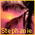 A close-up of a person's face with long dark hair, showing eyes and part of the nose against a pinkish background. The name 'Stephanie' appears in yellow text at the bottom.