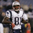 A pixelated image of a football player in a white jersey with number 81, standing on a field with blurred background.