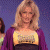 A 50x50 pixel animated contact sheet showing two frames of a woman in a purple cardigan over a yellow top against a blue background, with green text reading "Original Icons .com" on the right side.