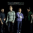 Five pixelated figures stand in a row against a black background, each wearing distinct clothing with visible color variations.