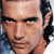 Static pixelated close-up of a man's face with dark hair and light skin, cropped to show forehead through chin against a blurred background.