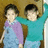 Two pixelated children stand side-by-side against a brown background, one in a teal shirt with arm raised, the other in purple and blue clothing, with text overlays reading "R.I.P U Morinn" and "you will always be in my memories i love you forever and always.".