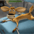 A pixelated cartoon animal with large ears and a long tail lies on its back on a blue surface, mouth open in a neutral expression, against a gray background.