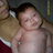 A baby in a light brown outfit with white trim lies on a dark surface, with pink text reading Karina Marie Martinez, June 28 2007, and Lubb Of Muh Life [1] on a black background.