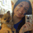A pixelated static image shows a person holding a small dog, with a camera visible on the right side of the frame.