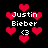 Pixelated red hearts float around white text reading "Justin Bieber" with a heart-eyes symbol on black background.