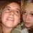 Two pixelated faces in close proximity, one with a broad smile and visible teeth, the other partially obscured.