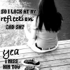 Black-and-white image of a person with long dark hair sitting on a wooden surface, facing away from the viewer, with text overlays reading "SO I LOOK AT MY REFLECTION AND SAY" and "YEA THIS HIM TOO".