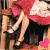 Animated contact sheet showing a woman in a red and white dress adjusting black high heels across five frames with pink heart symbols, plus static text "AWAITING MY PRINCE" on a black background.