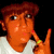 A person with brown hair and a white shirt makes a peace sign with their right hand, with yellow text overlays changing across frames.
