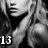 Pixelated grayscale image of a person in profile with hand near face, number 13 visible at bottom left.