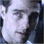 A 50x50 pixel animated buddy icon featuring a split composition with a grayscale close-up of Tom Cruise on the left and green text reading "Original Icons .com" on a dark green background on the right.