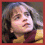 Three pixelated views of a person with long brown hair wearing a yellow and maroon striped sweater, arranged in a
