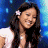 A 4-frame contact sheet of an animated AIM buddy icon featuring a woman with long dark hair and a white flower in her hair, alternating between two background colors and showing the American Idol logo on one frame.