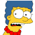 Pixelated cartoon character with yellow skin, blue hair, red bow tie, wide eyes, and open mouth showing teeth and tongue.