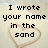 Pixelated text and heart symbols on a sandy background with visible water ripples.