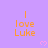 Purple background with orange text reading "I love Luke" and pink pixelated hearts scattered across the image.