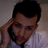 A pixelated image shows a person with dark hair and light skin resting their head on one hand, next to bold red text reading "JOEL MADDEN" on a black background.