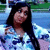 Pixelated image of a person with long dark hair wearing light blue clothing against a blurred background.