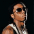 Pixelated image of a person with short dark hair wearing sunglasses and white earphones, viewed from the side against a black background.
