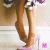 Animated close-up of a person's legs in high-heeled shoes with visible foot movement.