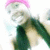 A pixelated figure with pink headwear and green clothing, partially visible against a bright background.