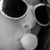 Black-and-white photo of a person blowing a bubblegum bubble, wearing large sunglasses, with blue text overlay reading "Thats what summers about blowing bubbles and big sunglasses".