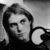 Black-and-white pixelated image of a person with long hair and a crescent moon symbol, next to text reading "GRUNGE IS DEAD.".