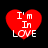 Four red heart shapes with white text "I'm In LOVE" arranged in a on black background, each heart displaying slight variations in pixelation and alignment