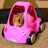 A pink cartoon car with a red hood and white headlights sits on a brown surface, while blue text appears over it.