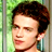 Static 48x48 pixel buddy icon showing a close-up of a person's face with dark curly hair, light skin tone, and visible ear against a greenish background.