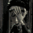 Animated sequence of a stylized character with large eyes and pale skin, transitioning from covering face to revealing wide-eyed expression against dark background.