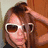 A person with brown hair and white sunglasses appears in the top-left quadrant, while a blue and black striped heart shape is in the top-right quadrant.