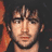 Pixelated portrait of a man with dark tousled hair and light stubble, shown in three distinct cropped views against varied backgrounds.