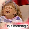 A child with light brown hair in a checkered shirt displays a strained facial expression with eyes squinted and mouth open, overlaid with text reading "Is it morning?".