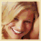 Pixelated image of a smiling person with blonde hair in four showing different angles and expressions