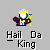 Pixelated character wearing yellow crown and purple robe holding yellow staff with multicolored top, standing above text reading "Hail Da King" on gray background.