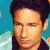 A contact sheet of two animated frames showing a person with dark hair and light skin against a blue background, next to green pixelated text reading "Original Icons .com" on a dark green background.
