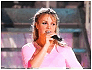 Britney Spears in a pink top singing into a microphone across three showing slight pose and expression shifts