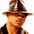 Static pixelated image of a person wearing a brown fedora hat and dark clothing against a white background.