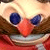 Pixelated close-up of a cartoon character's face with large blue eyes, red nose, and wide open mouth showing teeth.