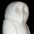 A pixelated grayscale figure with a rounded head and smooth body against a black background, showing subtle shading variations.