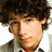 Pixelated portrait of a person with curly brown hair on a bright blue background with pink text.