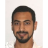 Pixelated portrait of a person with short dark hair, light brown skin, and a beard, wearing a white shirt against a light background.