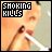 Pixelated image with 'SMOKING KILLS' text in blocky white letters on black background, showing a person exhaling smoke from a cigarette.