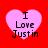 Four pink heart shapes on a red background, each containing the text "I Love Justin" in black pixelated font.